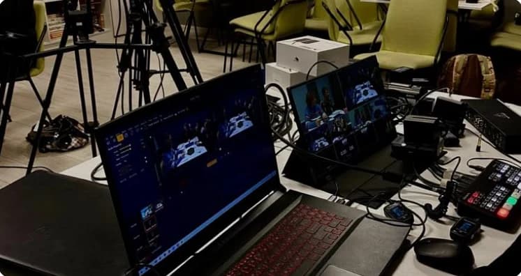 AAN TV production equipment: laptops and monitors running a live broadcast